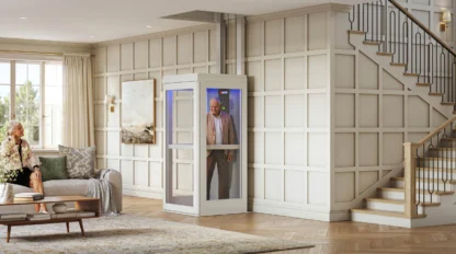 A man standing inside a home elevator