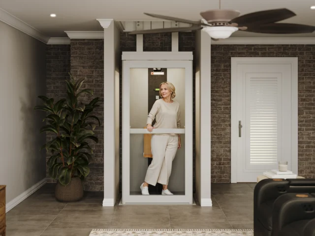 Middleaged woman in white, standing in an elevator with the door closed