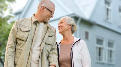 Senior couple in springtime jackets outside, smiling at each other