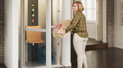 Woman carrying a heavy package into her Pollock elevator.