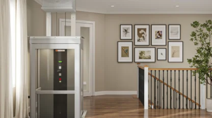 A home elevator is rising to the second floor of a residence, located near the top of the stairs.