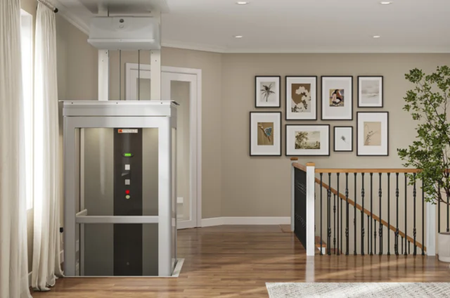 A home elevator is rising to the second floor of a residence, located near the top of the stairs.